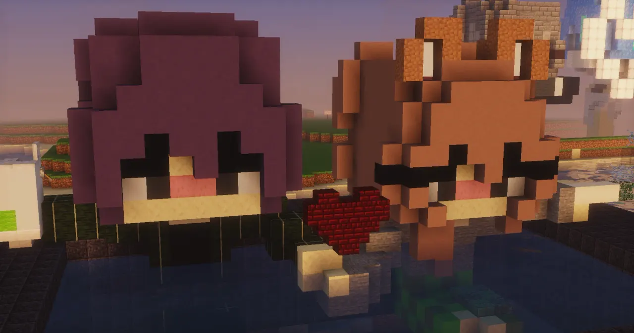 Two giant cute Minecraft character heads with a red heart, built on a KiwiSMP Creative plot