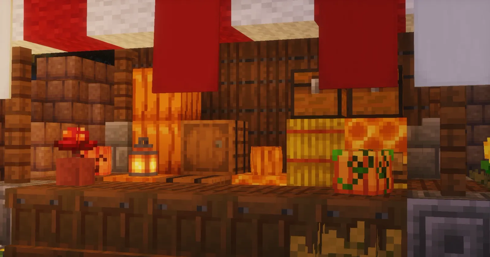 A Halloween market stall in the KiwiSMP lobby piled with pumpkins, hay bales and a lantern